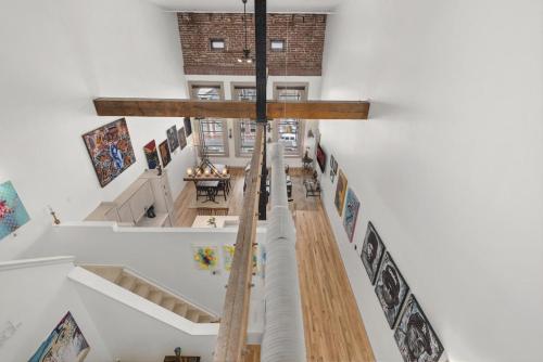 a cross hanging in a room with paintings on the walls at The Elevated Gallery - Historic Loft - Heart of Downtown - 98WalkScore in Denver