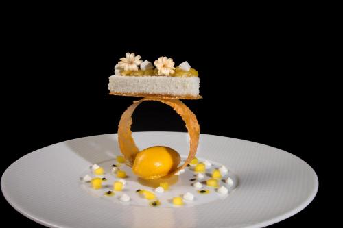 a piece of cake with an orange on a plate at La Côte Saint Jacques in Joigny