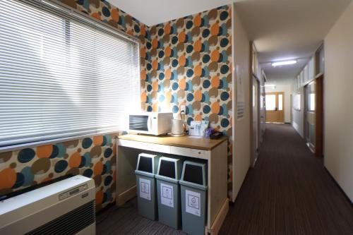 a room with a hallway with a kitchen with a window at たっこ宿 in Takko