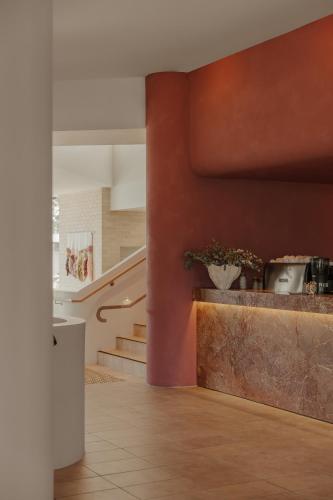 a living room with a counter and a staircase at The Clairfield Hotel in Mudgee