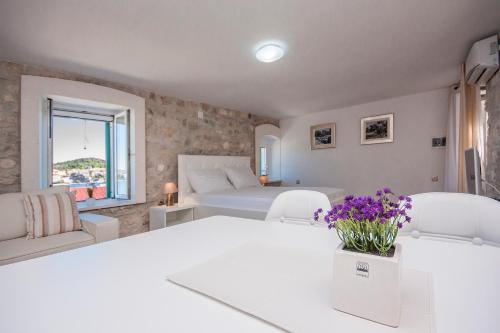 a bedroom with a white table and two white chairs at Apartments Dalmata in Krapanj