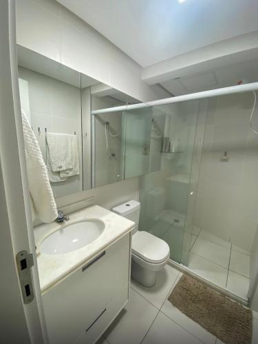 a bathroom with a toilet and a sink and a shower at Cobertura 435 - In mare bali in Parnamirim