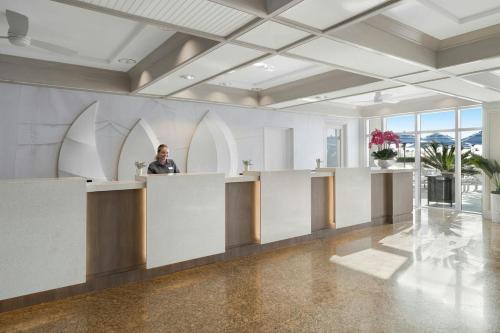a man standing at a counter in a lobby at Marriott Beachplace Towers 2BD in Fort Lauderdale