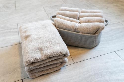 a pile of towels on the floor in a bathroom at HOSHIとUmitoはサウナで整う完全プライベート1棟貸でプロジェクター完備 in Nakijin
