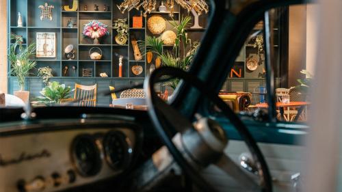 a room with potted plants on a wall at Ruby Zoe Hotel London by IHG in London