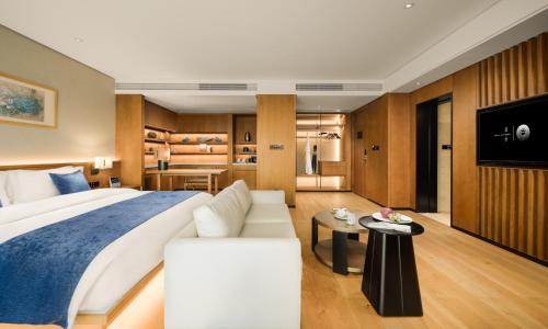a hotel room with a bed and a couch at The Lantern in Shunde