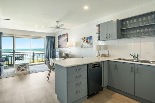 a kitchen with a view of the ocean at Apartment 9T in Lennox Head