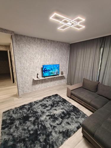 a living room with a couch and a flat screen tv at Agnes Apartament in Valmiera