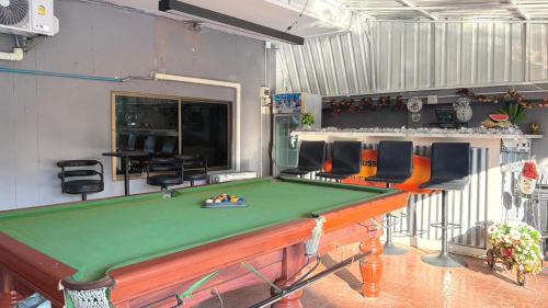 a room with a pool table and some chairs at Collection O Southern Star Resort Pattaya in North Pattaya