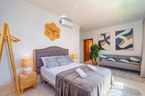 a bedroom with a bed and a chair in it at Villa Casa Luna by Villa Plus in Playa Blanca
