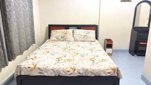 a bedroom with a bed with a white comforter at Collection O Southern Star Resort Pattaya in North Pattaya