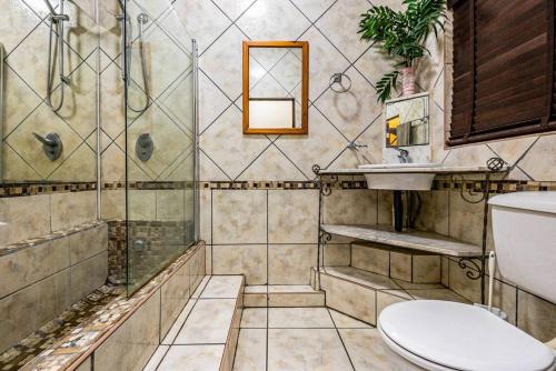 a bathroom with a shower and a toilet and a sink at Cabanas Del Mar 76 By Evermore in Kingsborough