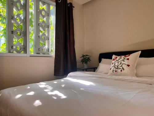 a bedroom with two beds and a window at EAIN-WORKplusSTAY in Bangkok