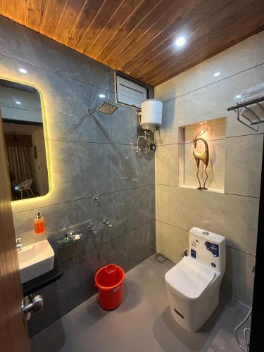 a bathroom with a toilet and a sink at Hotel Chunda Niwas in Dabok