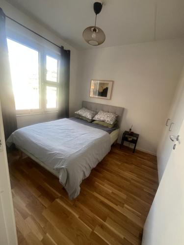 a bedroom with a bed and a window at Nice flat in Barkarby in Järfälla