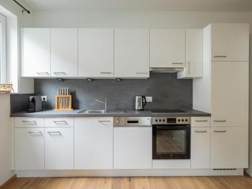 a white kitchen with white cabinets and a sink at Chalet in Turracher Höhe with Ski Slope Access in Turracher Hohe