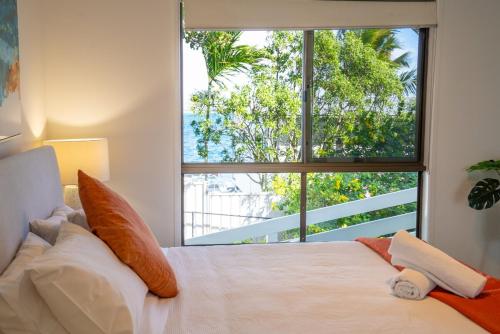 a bedroom with a large window and a large bed at Amity Treetops - Prime Location - Sleeps 7 in Amity Point