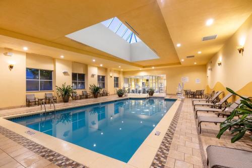 a swimming pool in a hotel lobby with a skylight at Wyndham Grand Oklahoma City Downtown in Oklahoma City