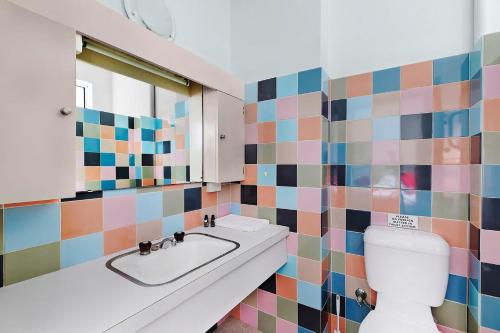 a bathroom with a sink and a toilet at The Sands Apartment 6 in The Entrance