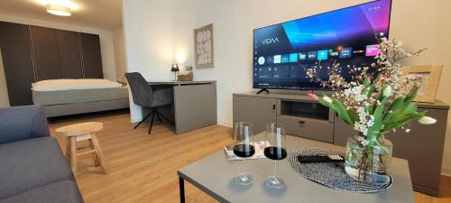 a living room with a couch and a large screen tv at Obermain Living in Bad Staffelstein