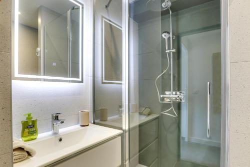 a bathroom with a sink and a shower at Appartement Santocha in Capbreton