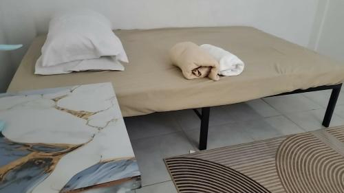 a stuffed dog laying on a couch in a room at Eastdee AIRCON ROOM - RO1 in Biqui