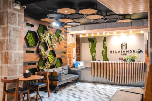a lobby of a restaurant with a table and chairs at Sunday Belajandro Hotel in Angeles