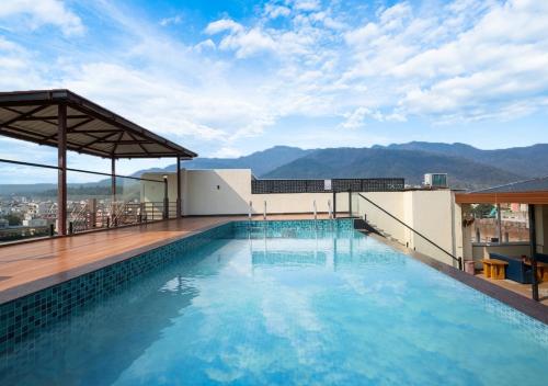 a swimming pool on the roof of a building at Saltstayz Autograph - Rishikesh Near Triveni Ghat in Rishīkesh