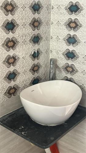 a white bowl sink on a counter in a bathroom at Peaceful & hygienic stay , Ideal for working professionals, Great for solo female travelers in Pune