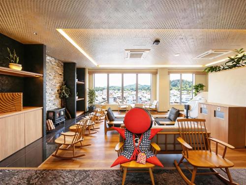a waiting room with a red chair in the middle at Hotel and Spa Gift TAKAYAMA in Takayama