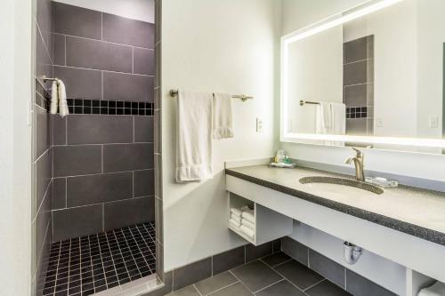 a bathroom with a sink and a mirror at The Wallhouse Hotel, an Ascend Collection Hotel in Walnut Creek