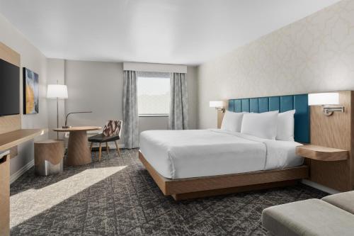 a hotel room with a large bed and a desk at DoubleTree by Hilton Salisbury in Salisbury