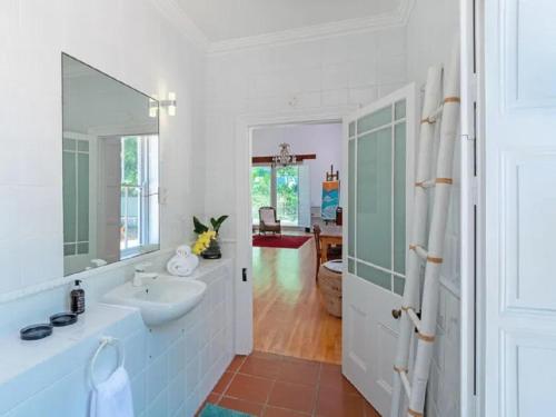a bathroom with a sink and a mirror at Mont Angelis in Stellenbosch