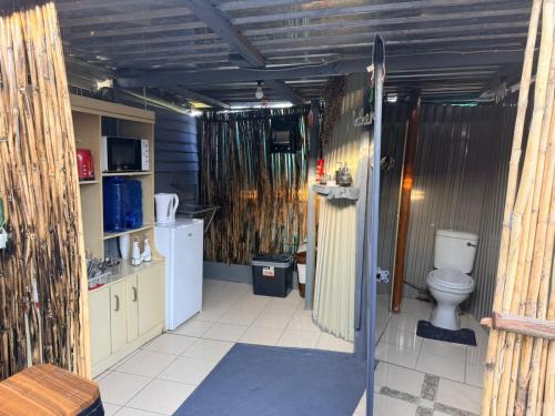 a bathroom with a toilet and a sink at Day&Night Stay in Johannesburg