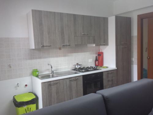 a kitchen with a sink and a stove top oven at Bed And Breakfast Marina d'Aspra in Bagheria