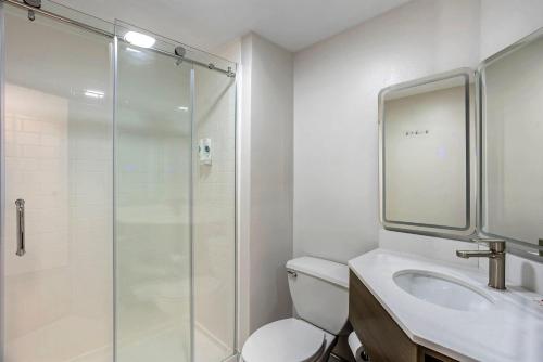 a bathroom with a shower and a toilet and a sink at Comfort Inn & Suites Harrisburg-Hershey North in Manor Acres