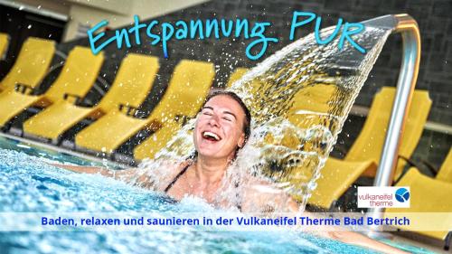 a woman in the water in a swimming pool at Haus Alleegarten in Bad Bertrich