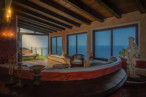 a room with a bath tub in a room with windows at Nido Paraiso in Santa Úrsula