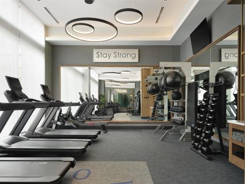 a gym with rows of treadmills and machines at Tempo By Hilton Nashville Midtown in Nashville