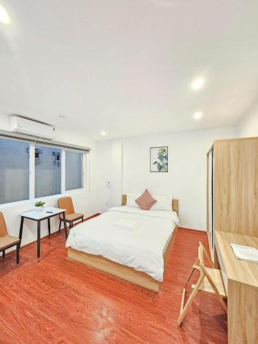 a bedroom with a bed and a table and chairs at Lakenest 06 - Quiet Place in Hanoi