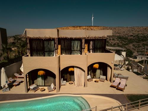 a building with a swimming pool and a resort at No908 Sunset HOTEL in Çeşme