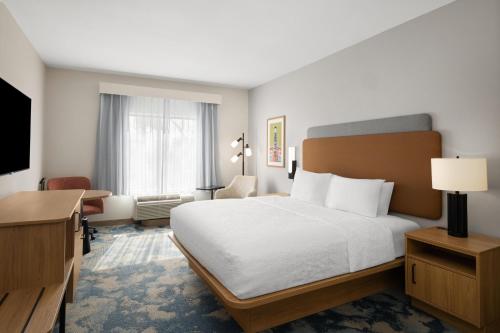 a hotel room with a bed and a television at Hampton Inn & Suites Ontario in Ontario