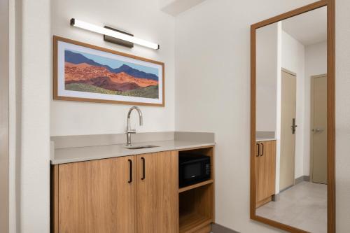 a bathroom with a sink and a mirror at Hampton Inn & Suites Ontario in Ontario
