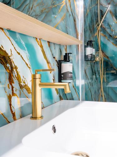 a bathroom with a sink and a mirror at Hôtel de la Mer in Hyères