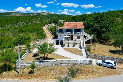 an aerial view of a house with a car parked in front at Antonija in Bašić