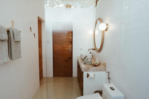 a bathroom with a toilet and a sink at Punta Punta Surf Retreat in General Luna