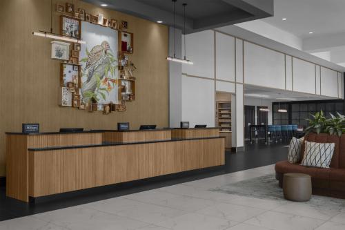 a lobby with a reception desk and a couch at Embassy Suites by Hilton Tuscaloosa Alabama Downtown in Tuscaloosa