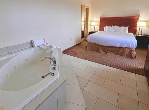 a hotel room with a bath tub and a bed at Econo Lodge City Centre in Kingston