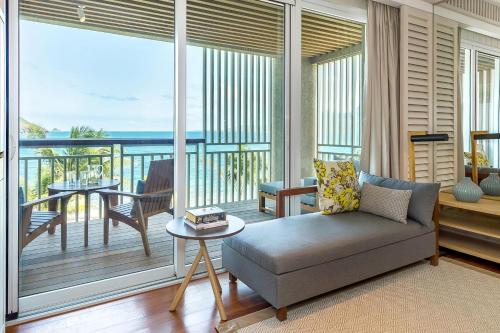 a living room with a couch and a balcony at Park Hyatt St. Kitts in Christophe Harbour