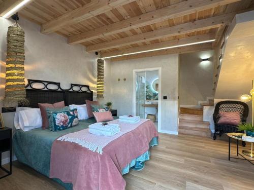 a bedroom with a large bed and a staircase at Castaños - Casal do Conde in Caldas de Reis